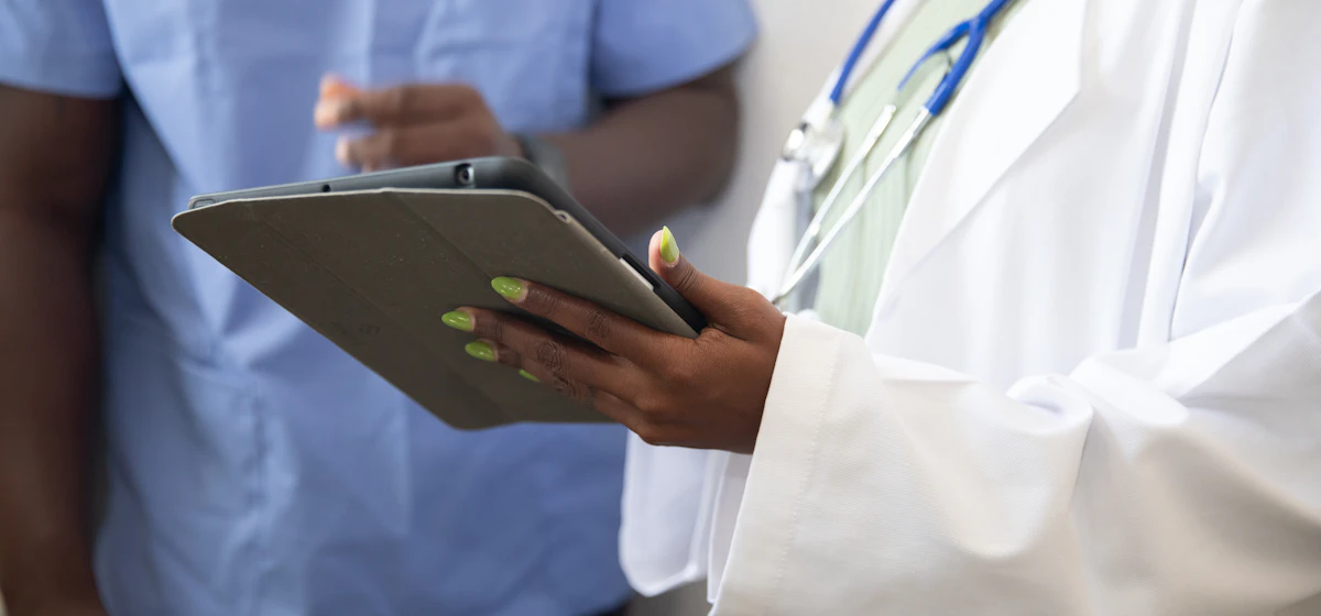 Doctor and nurse reviewing information on a tablet